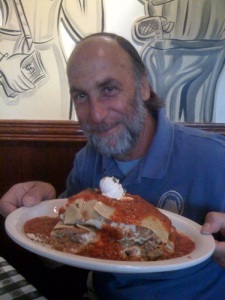 Art Cohn enjoying a large plate of lasagna
